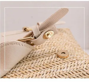 Woven straw backpack detail shot featuring PU leather strap and convenient magnetic snap closure.
