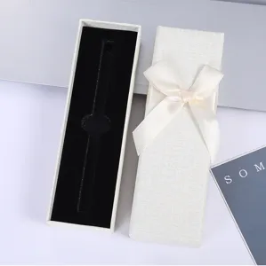 Vista detallada de elegante caja de regalo con lazo, interior de terciopelo y tapa texturizada.