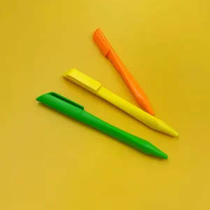 Close-up detail view of colorful triangular plastic ballpoint pens, matte finish gift pens.