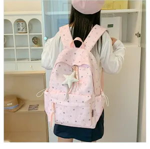 Pink star pattern backpack detail view, showing cute star pendant and spacious front pocket.