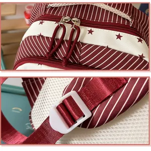 Close-up details of casual backpack showing red striped fabric, cute stars pattern and sturdy buckle.