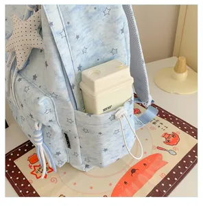 Detailed view of cute blue star print school backpack with side pocket and star pendant.