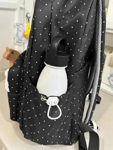 Black and white polka dot backpack for women, cute college style school bag with large capacity.