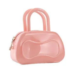 Close-up detail of the pink PVC jelly boston bag showing smooth texture and cute bow embossment.