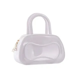 White PVC jelly Boston bag detail showing dual top handles and gold zipper pull accent.