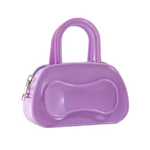 Purple PVC jelly handbag featuring glossy finish, double top handles, zipper closure and style.