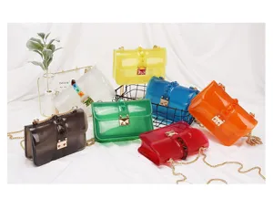 Transparent PVC jelly crossbody bag with metal chain and chic stud details for women.