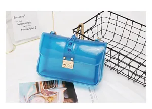 Blue translucent PVC crossbody bag with pyramid studs and gold chain. Detail shot.