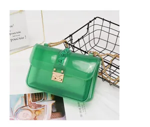 Green transparent PVC shoulder bag detail, elegant chain strap with pyramid stud design.