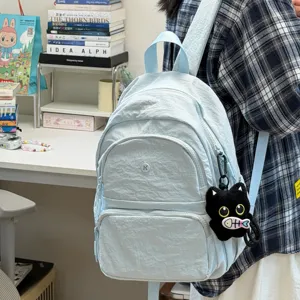 Light blue student backpack variant with cute black cat plush pendant and large capacity storage.