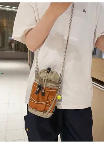 Detail view of tactical outdoor water bottle bag with drawstring and orange grid pattern.