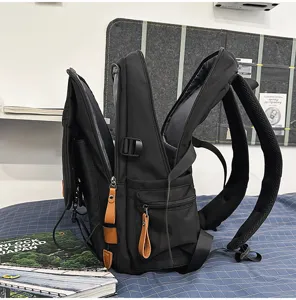 Vista lateral detallada de una mochila de viaje negra con múltiples compartimentos.