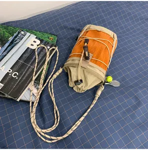 Outdoor tactical water bottle bag detail view, orange grid waterproof sling pouch for hiking.