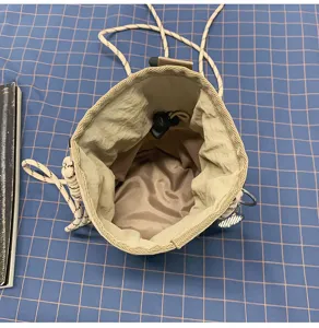 Detail view of outdoor waterproof drawstring water bottle bag interior structure and strap features.