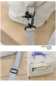 Detail view of travel duffel bag strap buckles, adjustable slide and front zipper pocket.