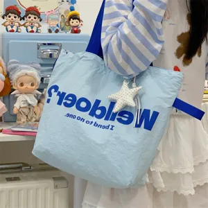 Large capacity canvas tote bag for women, stylish letter print shoulder handbag for daily commute.