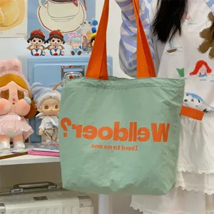 Green canvas tote bag with orange handles, large capacity casual shoulder handbag for women
