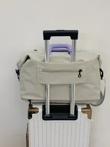 Large capacity travel duffle bag with trolley sleeve and waterproof fabric for trips.
