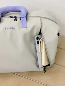 Large capacity travel duffel bag with expandable design, stylish purple handles and handy pockets.
