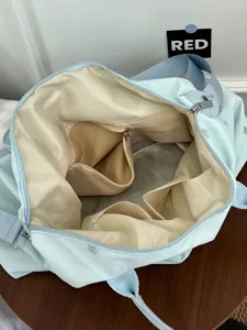 Large capacity light blue travel duffel bag, top-down view showing interior compartments.