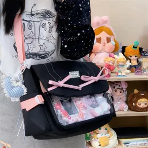 Detailed view of the black ita shoulder bag with pink bows and clear window for pins.
