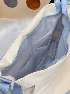 Detailed view of the interior compartment and pocket design of the women's canvas shoulder bag.