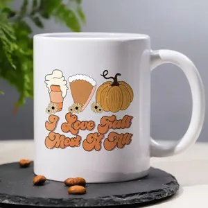 Witte keramische koffiemok met herfstthema print, retro pompoen grafisch en seizoentekst.