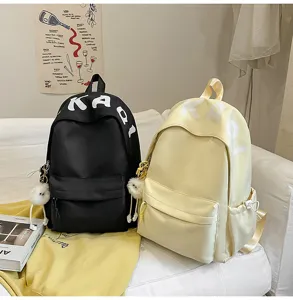 Minimalist school backpack for students, casual daily daypack with cute fluffy ball pendants.