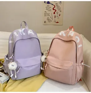Macaron style student backpack detail shot, casual daily school bag with cute plush pendant.