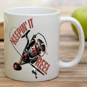 White ceramic coffee mug with fishing reel graphic print detail for office desk use.