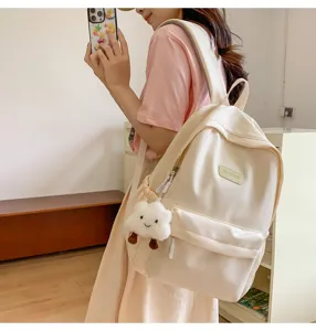 Minimalist casual large capacity women backpack in solid beige with cute cloud pendant.