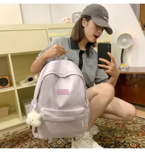 Simple solid color casual backpack with large capacity for daily student school use.
