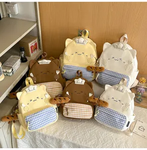 Cute cartoon canvas school backpack with cat ears and plaid pocket for daily casual travel style.