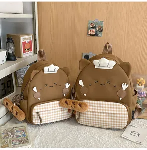 Cute brown backpack detail showing soft fabric, plush chef hat, and plaid pocket design.
