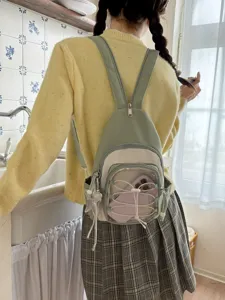 Mini ita backpack and chest bag worn on back, featuring clear front pocket and cute charm.