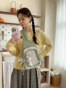 Fashionable light green ita sling bag with transparent front pocket and cute star pendant.