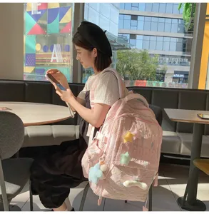 Detailed view of the cute pink Japanese ins style casual backpack with star charms and straps.