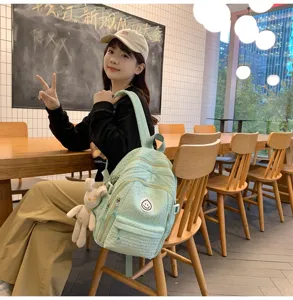 Casual light green backpack for women and students, featuring cute design and roomy compartments.