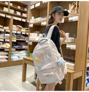 Japanese ins style casual backpack with colorful stripes and cute star charms for daily school.