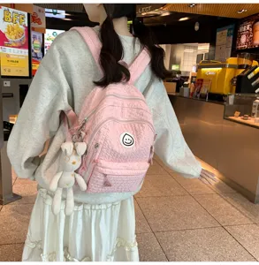 Sweet pink quilted backpack for teen girls, cute soft style school bag with plush bunny charm.
