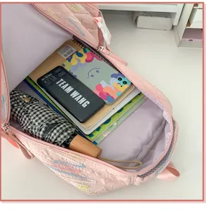 Detailed view of pink quilted school backpack interior, spacious storage for daily items.