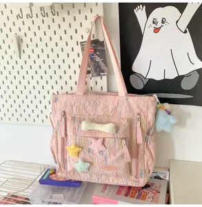 Pink quilted tote bag with cute plush star and bone charms, casual shoulder bag for daily use.