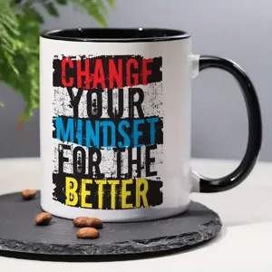 Ceramic coffee mug with motivational quote print, black handle design for office and home use.