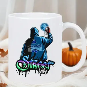Close-up detail of a white ceramic coffee mug with street graffiti print and orange pumpkin decor.