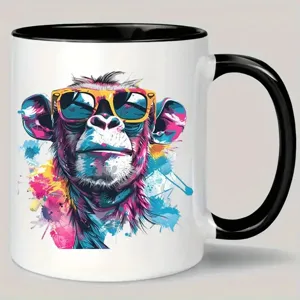 Close-up detail of ceramic coffee mug featuring vibrant graffiti monkey print and black handle.