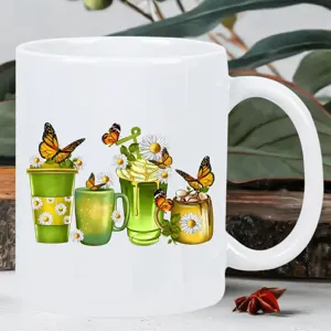 Close-up detail of white ceramic coffee mug featuring vibrant floral and butterfly printed design.