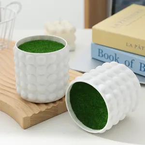 White bubble textured plant pot with green moss detail for desktop decor and interior styling.