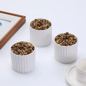 Nordic white fluted flower pot detail showcasing pebble filling and minimalist design.