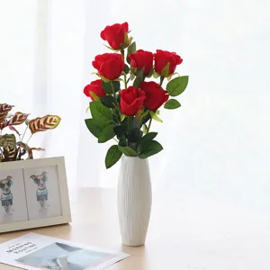 Artificial red roses bouquet in white ceramic vase, elegant home decor and floral arrangement.