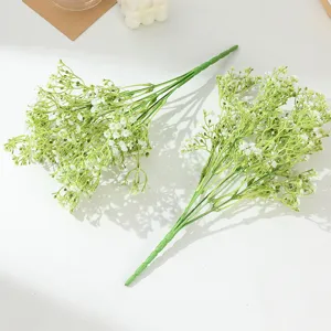 Photo de détail de gypsophile artificiel, gros plan de fleurs blanches et tiges vertes.